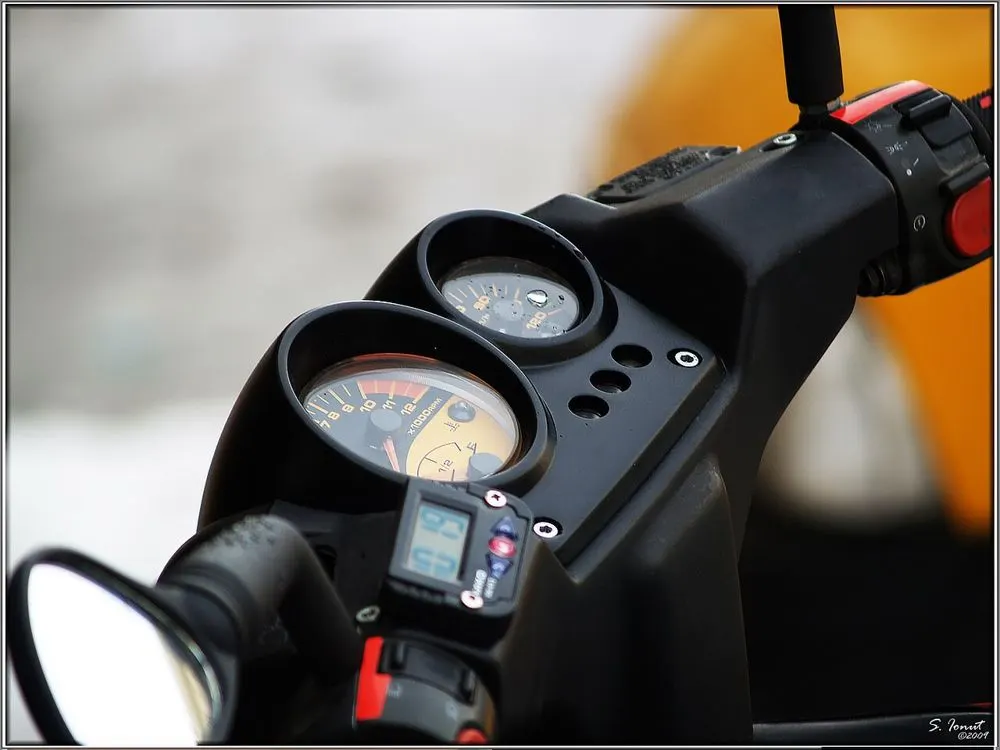 Close-up of a scooter's dashboard gauges