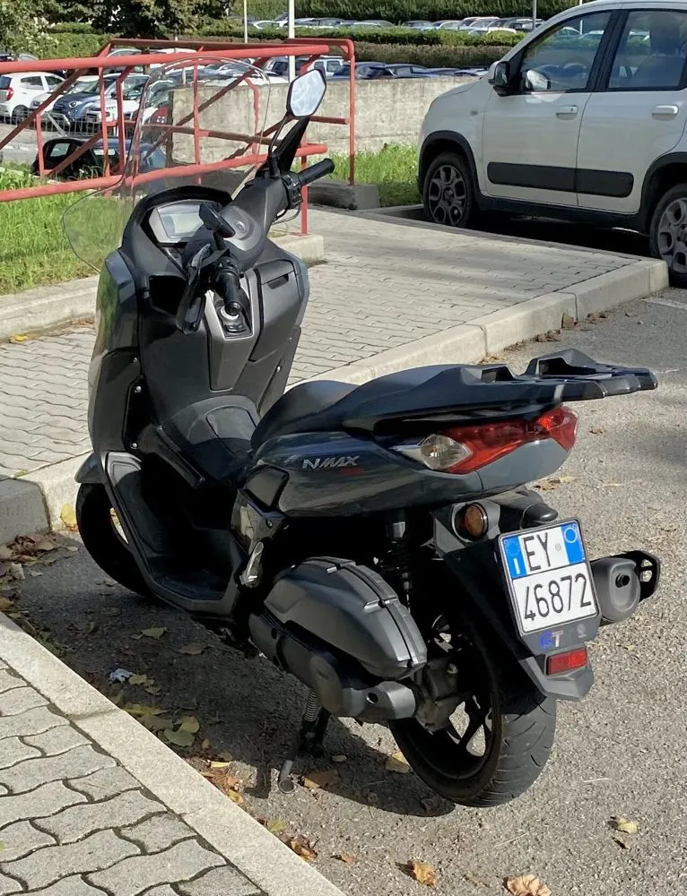 Rear of a grey scooter with its number plate, photographed at check-in
